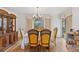 Elegant dining room featuring a chandelier, large window, and traditional furniture set at 8484 E Radcliff Ave, Denver, CO 80237