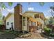 The two story home features a brick chimney and a second story patio at 8484 E Radcliff Ave, Denver, CO 80237