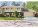 Charming two-story home featuring a well-maintained lawn, mature trees, and an attached two-car garage at 8484 E Radcliff Ave, Denver, CO 80237