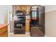 Kitchen appliances including microwave, range, and refrigerator, complemented by tiled countertops and backsplash at 8484 E Radcliff Ave, Denver, CO 80237