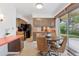 Eat-in kitchen area featuring wood cabinets, adjacent appliances, and a sliding glass door to the exterior at 8484 E Radcliff Ave, Denver, CO 80237