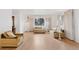 Bright living room showcasing hardwood floors, a large window with curtains, and neutral wall paint at 8484 E Radcliff Ave, Denver, CO 80237