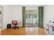 Bright office area with a sliding glass door, wood floors, a work desk, and built-in shelving at 8484 E Radcliff Ave, Denver, CO 80237
