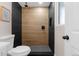 Contemporary bathroom showcasing black and wood tile in a walk-in shower at 8051 Clarkson Ct, Denver, CO 80229
