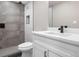 Bathroom featuring updated gray tile in shower with glass, and white vanity with stone countertop at 8051 Clarkson Ct, Denver, CO 80229