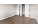 Bedroom featuring wood flooring, neutral walls, and a double closet with white doors at 8051 Clarkson Ct, Denver, CO 80229