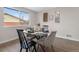 Bright dining room featuring a glass table, modern decor, and a large window at 8051 Clarkson Ct, Denver, CO 80229