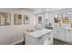 Bright, modern kitchen with white cabinetry, a quartz island, and stainless steel appliances at 8051 Clarkson Ct, Denver, CO 80229