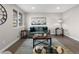 Cozy living room with hardwood floors, comfortable seating, and a large window for natural light at 8051 Clarkson Ct, Denver, CO 80229