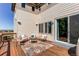 Inviting back deck with outdoor seating, a coffee table and a rug, perfect for relaxing and entertaining at 10152 Southlawn Cir, Commerce City, CO 80022