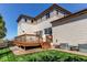 Outdoor space with wooden deck and a well-maintained backyard, ideal for relaxation and outdoor enjoyment at 10152 Southlawn Cir, Commerce City, CO 80022