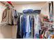 Walk-in closet features organized storage with shelving and hanging space for clothes at 10152 Southlawn Cir, Commerce City, CO 80022