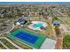 Aerial view of community pool, tennis court, playground, and surrounding homes at 10152 Southlawn Cir, Commerce City, CO 80022