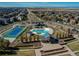 Aerial view of community pool, clubhouse, tennis court and surrounding neighborhood at 10152 Southlawn Cir, Commerce City, CO 80022