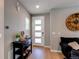 Home entryway featuring modern door with glass panels, table, hardwood floors, and a clock at 10152 Southlawn Cir, Commerce City, CO 80022