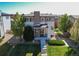 Beautifully landscaped front yard with stone walkway leading to a charming two-story home at 10152 Southlawn Cir, Commerce City, CO 80022