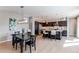 Open-concept design with a kitchen island, stainless steel appliances, and stylish pendant lighting at 10152 Southlawn Cir, Commerce City, CO 80022