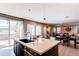 This gourmet kitchen features a large island, modern appliances, and seamless transition to the dining and living spaces at 10152 Southlawn Cir, Commerce City, CO 80022
