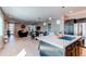 Open floor plan with a modern kitchen island flowing into a sun-filled living area perfect for entertaining guests at 10152 Southlawn Cir, Commerce City, CO 80022