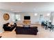 Inviting living room with comfortable sofas, large windows, and an open layout for entertaining and relaxation at 10152 Southlawn Cir, Commerce City, CO 80022