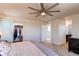 This primary bedroom features a ceiling fan, closet, and ensuite bathroom at 10152 Southlawn Cir, Commerce City, CO 80022