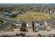 Aerial view of the neighborhood featuring a park, tennis court, and green spaces at 10152 Southlawn Cir, Commerce City, CO 80022