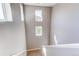 Bright stairway featuring light gray walls with large windows allowing ample natural light to flow throughout the space at 10152 Southlawn Cir, Commerce City, CO 80022