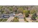 Aerial view of a home with a spacious yard, an attached two-car garage, and mature trees at 835 S Geneva St, Aurora, CO 80247