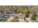Aerial view of a residential neighborhood showcasing a home with a spacious yard and mature trees at 835 S Geneva St, Aurora, CO 80247