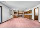 Cozy basement featuring a brick fireplace, built-in cabinets, and ample space for entertainment at 835 S Geneva St, Aurora, CO 80247