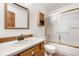 Bathroom showcasing a vanity, toilet, and shower with sliding glass doors at 835 S Geneva St, Aurora, CO 80247