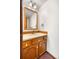 Bathroom featuring oak vanity with mirror at 835 S Geneva St, Aurora, CO 80247