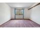 Bedroom featuring a window with blue curtains and a shelf mounted on the wall at 835 S Geneva St, Aurora, CO 80247
