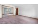 Bedroom featuring closet with mirrored doors and a window with blue curtains at 835 S Geneva St, Aurora, CO 80247