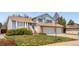 Charming two-story home featuring a well-manicured lawn, mature landscaping, and an attached two-car garage at 835 S Geneva St, Aurora, CO 80247