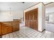 Functional kitchen with classic cabinetry, closet space, and seamless open view to the living space at 835 S Geneva St, Aurora, CO 80247