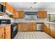 Inviting kitchen with wood cabinetry, stainless steel appliances, and a bright window at 835 S Geneva St, Aurora, CO 80247