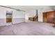Spacious living room featuring a wooden entrance door and staircase, with an open layout to the kitchen at 835 S Geneva St, Aurora, CO 80247