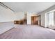 Bright and expansive living room with a stairway, double doors and an open layout to the kitchen at 835 S Geneva St, Aurora, CO 80247
