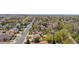 A home with a well-manicured lawn on a street lined with mature trees and sidewalks at 835 S Geneva St, Aurora, CO 80247