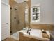 Modern bathroom featuring a walk-in shower, a luxurious tub, and elegant tile work at 11886 E Fair Ave, Greenwood Village, CO 80111