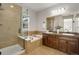 Bright bathroom featuring a glass shower, a soaking tub and double vanity sinks at 11886 E Fair Ave, Greenwood Village, CO 80111
