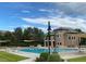 Sparkling community pool with ample seating and shade, surrounded by lush landscaping at 11886 E Fair Ave, Greenwood Village, CO 80111
