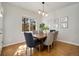 Dining room featuring a table, chairs, light fixture and art at 11886 E Fair Ave, Greenwood Village, CO 80111