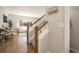 Welcoming hallway with wooden staircase and views into the bright and airy living room at 11886 E Fair Ave, Greenwood Village, CO 80111