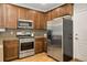 Kitchen with stainless steel appliances and ample cabinetry at 11886 E Fair Ave, Greenwood Village, CO 80111