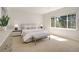 Bright main bedroom with neutral paint, large windows, and bench seating at 11886 E Fair Ave, Greenwood Village, CO 80111