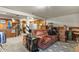 Unfinished basement with a pink sofa, kitchenette, and plenty of storage space at 4231 S Fairplay Cir # A, Aurora, CO 80014