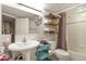 Bathroom featuring a modern vanity, floating shelves, tub with shower and toilet at 4231 S Fairplay Cir # A, Aurora, CO 80014