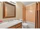 Cozy bathroom featuring a vanity with a stylish mirror, shower over tub, and a tiled accent wall at 4231 S Fairplay Cir # A, Aurora, CO 80014